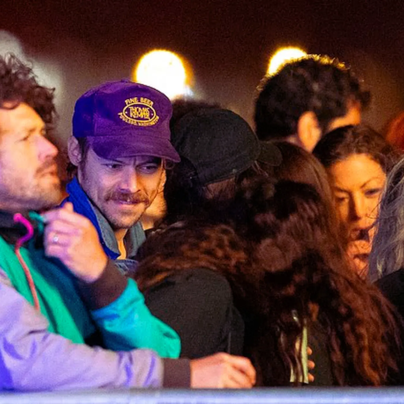 image_68465fe296532 Harry Styles Laughs With Friends at London Festival — What’s He Hiding From Fans?