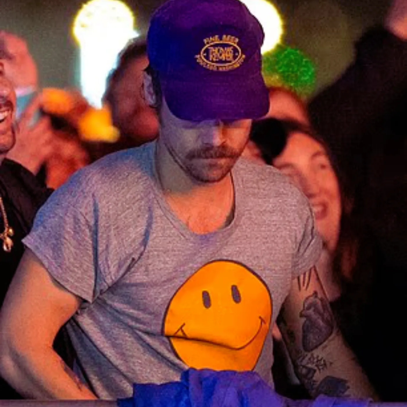 Harry Styles Laughs With Friends at London Festival — What’s He Hiding From Fans?